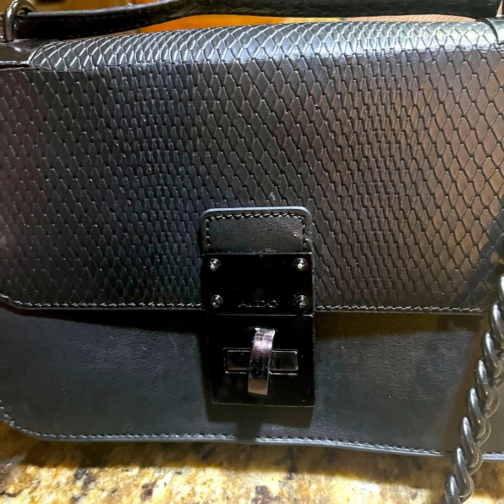 ALDO Leather shoulder bag with leather and chain shoulder strap.
